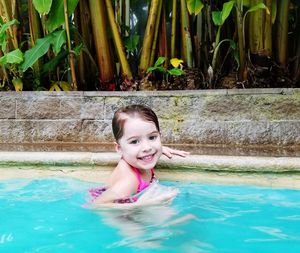 Portrait of young girl  swimming in hitsprings happy smiling 