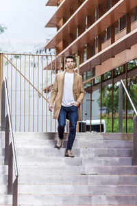 Full length portrait of young woman on staircase