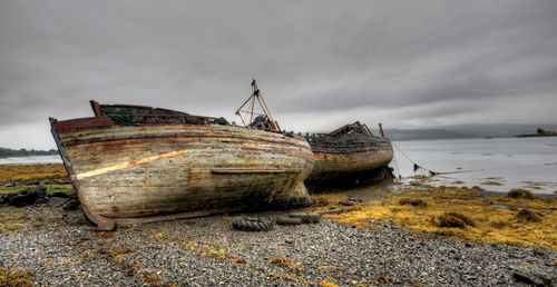 Abandoned wooden fishing boats in the coast of the isle of mull in scotland.