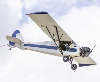 Low angle view of airplane against sky