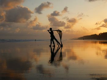 A fisherman with a beautiful sunset background 