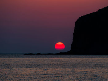 Scenic view of sea against romantic sky at sunset