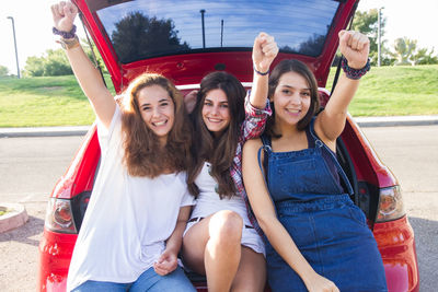 Portrait of happy female friends sitting in car