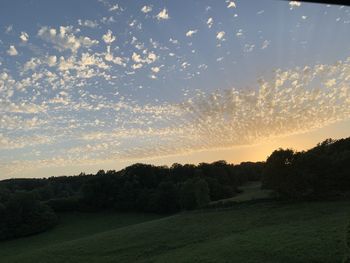 Scenic view of field against sky during sunset