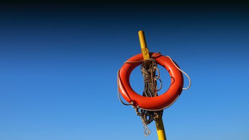 Low angle view of basketball hoop against clear blue sky