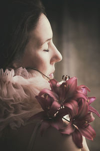 Close-up of young woman holding flower