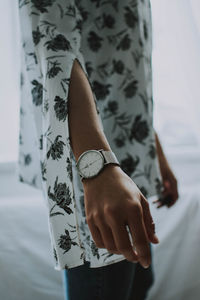 Midsection of woman wearing wristwatch