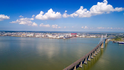 High angle view of bridge over river against sky in city