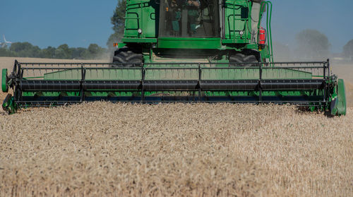 Combine harvester harvesting crops on agricultural field