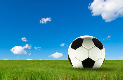 Ball on field against blue sky
