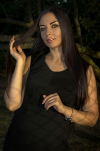 Portrait of beautiful woman standing in park