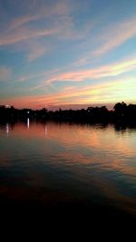 Scenic view of lake against romantic sky at sunset