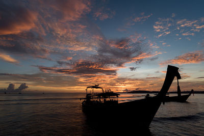 Silhouette boat on sea against sky during sunset