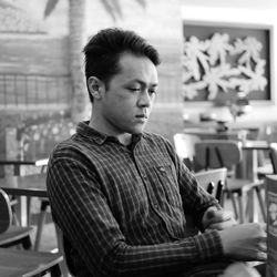 Portrait of young man sitting on chair