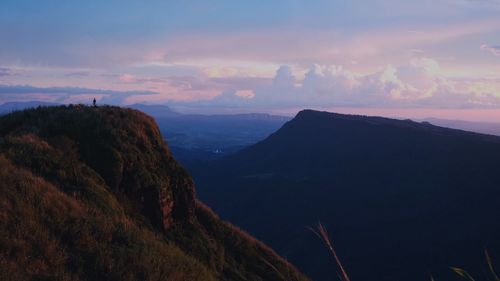 Scenic view of mountains against sky at sunset