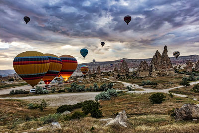 Hot air balloons flying over landscape