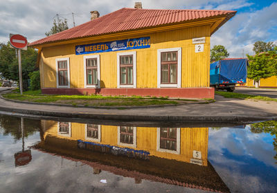 Reflection of building in lake against sky