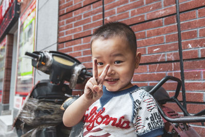 Portrait of cute boy against wall