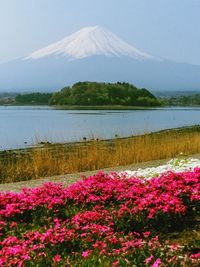 Scenic view of lake by mountain against sky