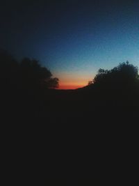 Silhouette trees against sky during sunset