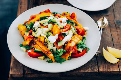 Detox dinner from quinoa salad with vegetables, cherry tomatoes and goat cheese. vegetarian food.