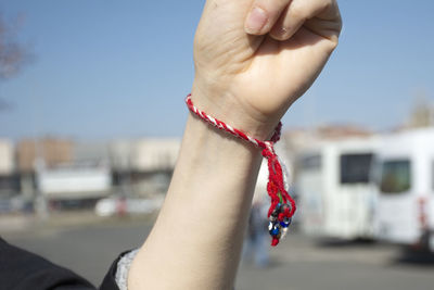 Midsection of woman against sky in city