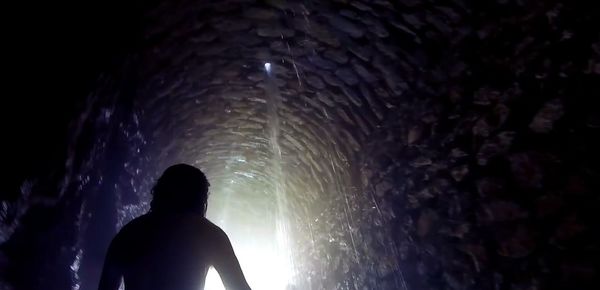 Man splashing water in tunnel