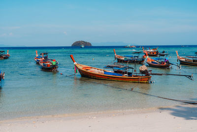 Boats in sea against sky