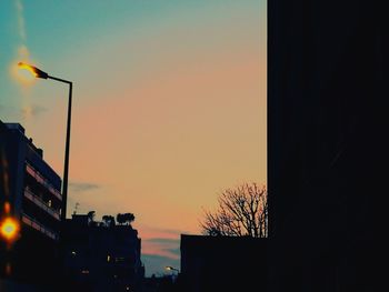 Low angle view of silhouette buildings against sky during sunset