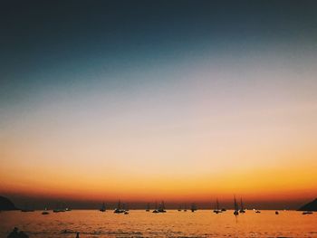 Scenic view of beach against clear sky during sunset