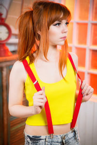 Beautiful young woman standing indoors