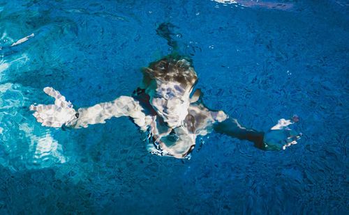 High angle view of girl swimming in pool