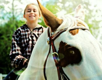 Happy girl riding horse