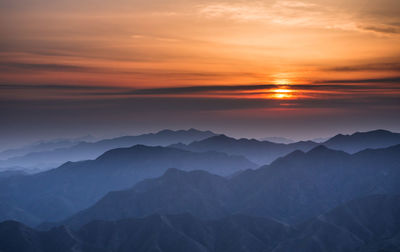 Scenic view of sunset over mountains