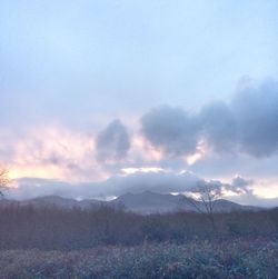 Scenic view of mountains against cloudy sky