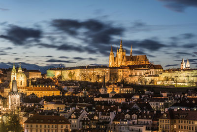 Aerial view of historical buildings in city against cloudy sky