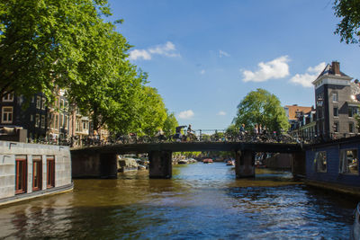 Bridge over river with buildings in background