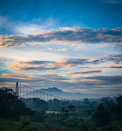 Scenic view of bridge against sky during sunset