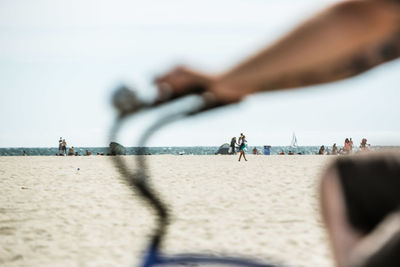 People on beach against sky