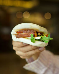 Close-up of hand holding burger