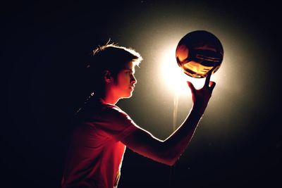 Side view of boy with ball