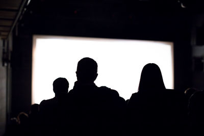 Rear view of silhouette people in theater
