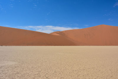 Scenic view of desert against blue sky