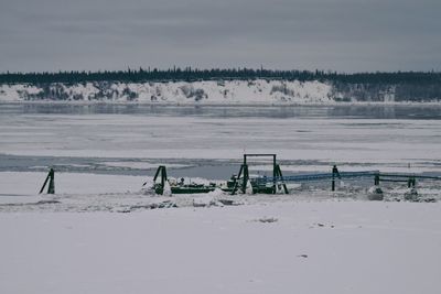 Scenic view of beach against sky during winter