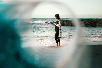 Full length of woman standing in sea