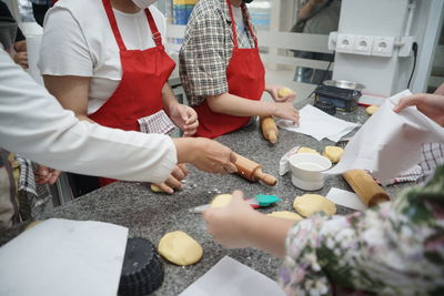 Midsection of woman preparing food at table