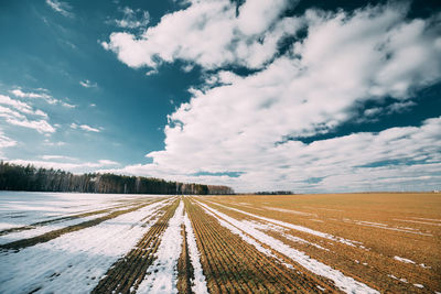 Scenic view of snowy field against sky