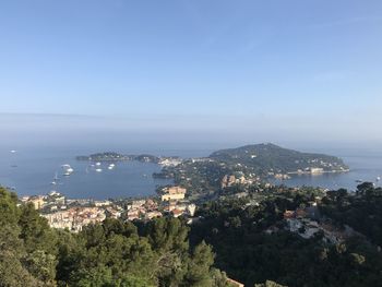 High angle view of townscape by sea against sky