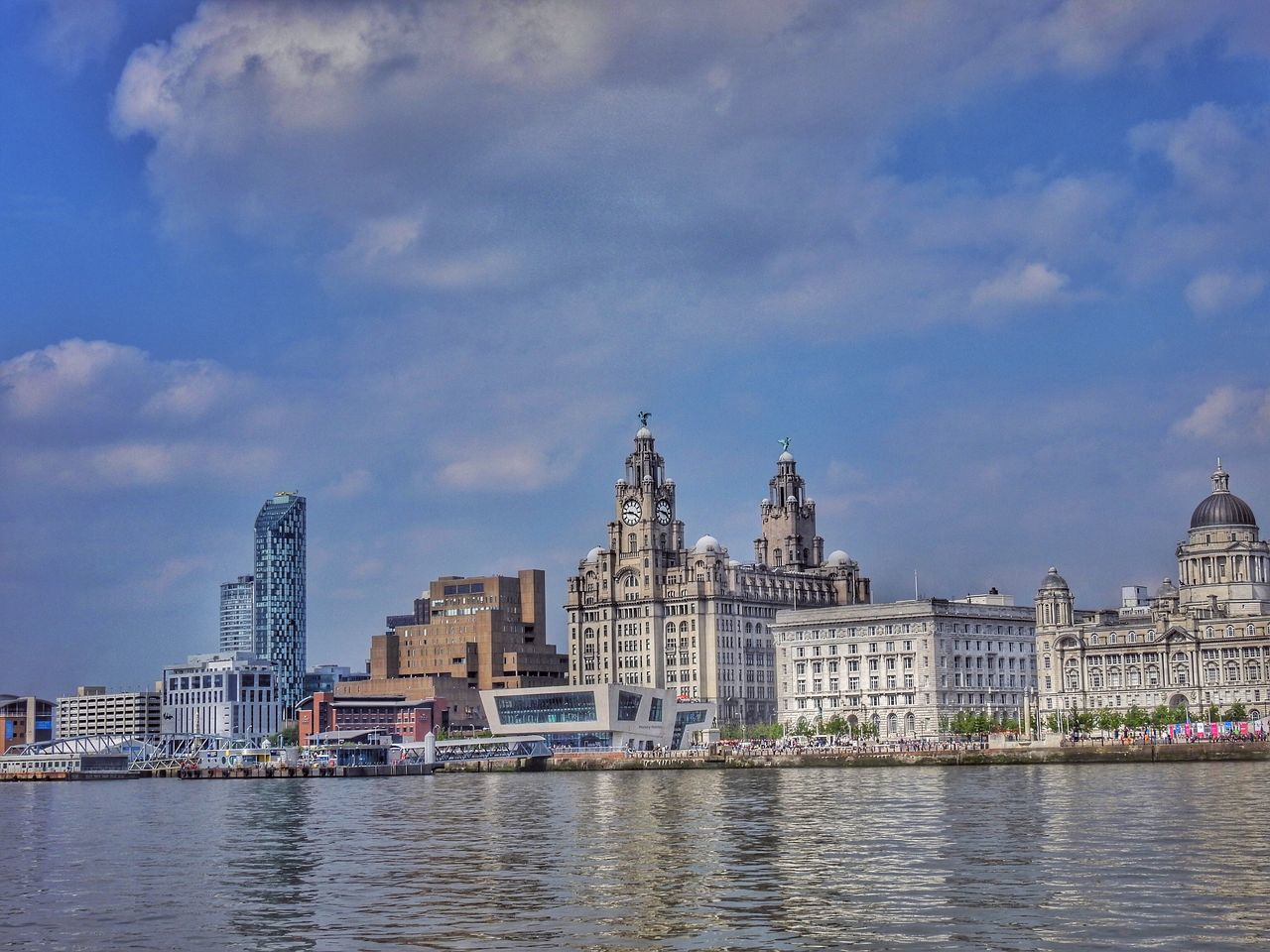 architecture, water, building exterior, waterfront, built structure, sky, river, city, cloud - sky, rippled, cloud, cityscape, residential building, canal, residential structure, cloudy, building, outdoors, no people, residential district