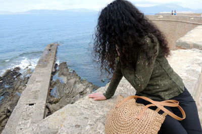 Rear view of woman looking at sea shore